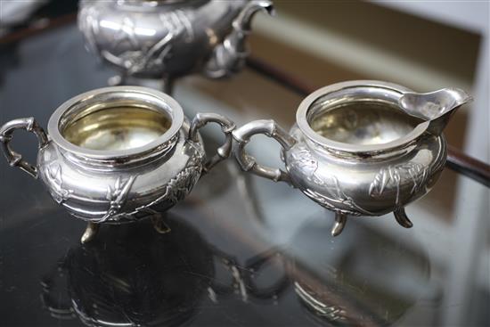 A late 19th/early 20th century Chinese Export three piece silver tea set by Wang Hing, Hong Kong, gross 31.5 oz.
